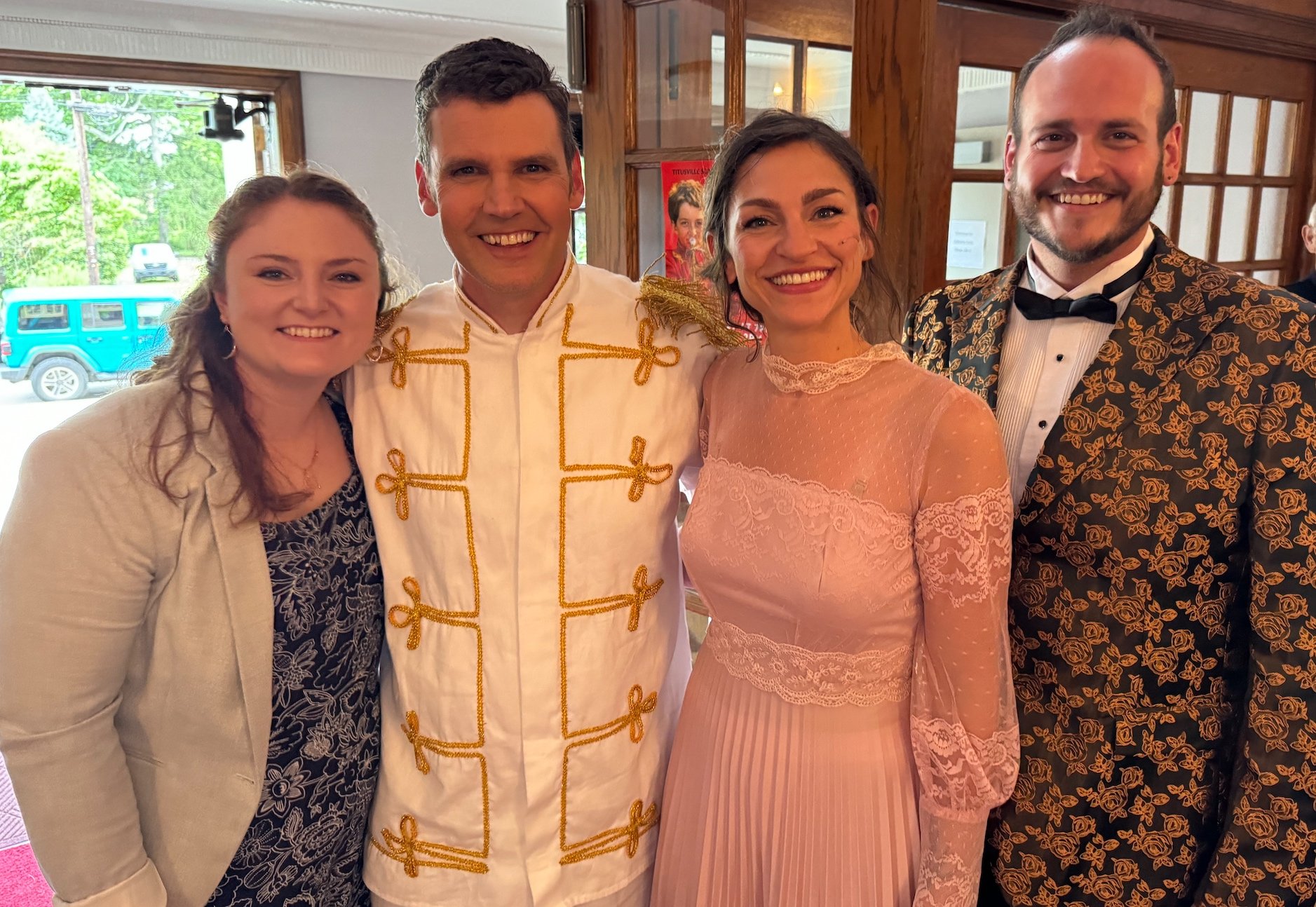 Four smiling people looking at the camera